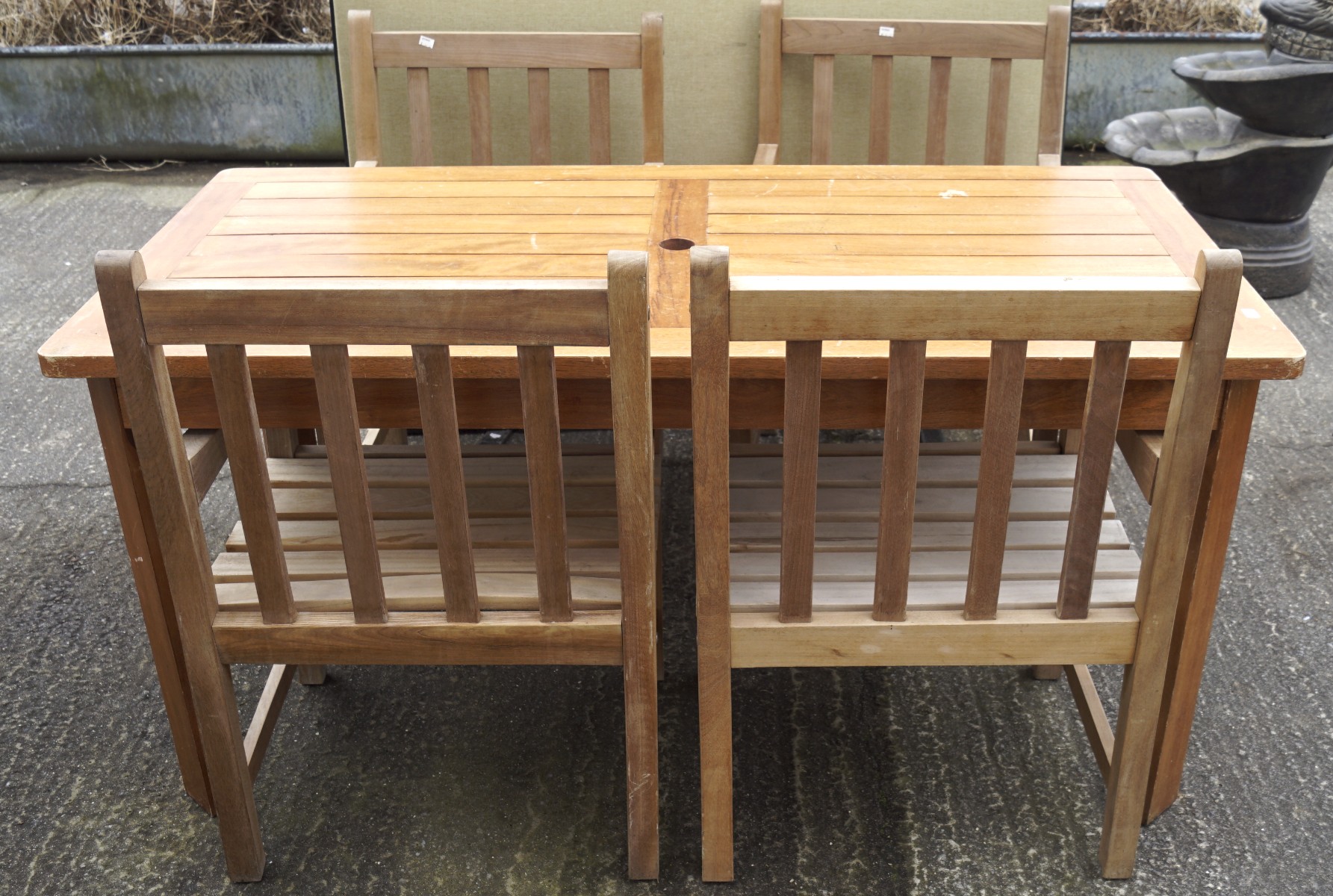 A modern garden table and four matching chairs,