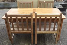 A modern garden table and four matching chairs,