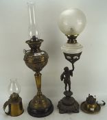 Two tall oil lamps and two smaller hand examples,
