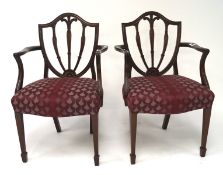 A pair of mahogany shield back elbow chairs