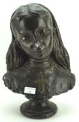 A plaster bust of a yound lady, painted black and on a circular plinth,