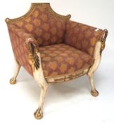 A painted and gilt upholstered armchair wth carved swan head arms and animal legs with claw and