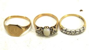 Three 9ct gold and yellow metal rings,