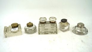 A collection of five glass inkwells,