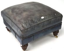 A pale blue leather foot stool on turned supports and casters,