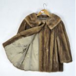 A vintage ladies mink fur coat, with brown silk lining,