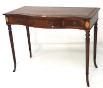 A 20th century mahogany desk with serpentine front and gilt tooled top,