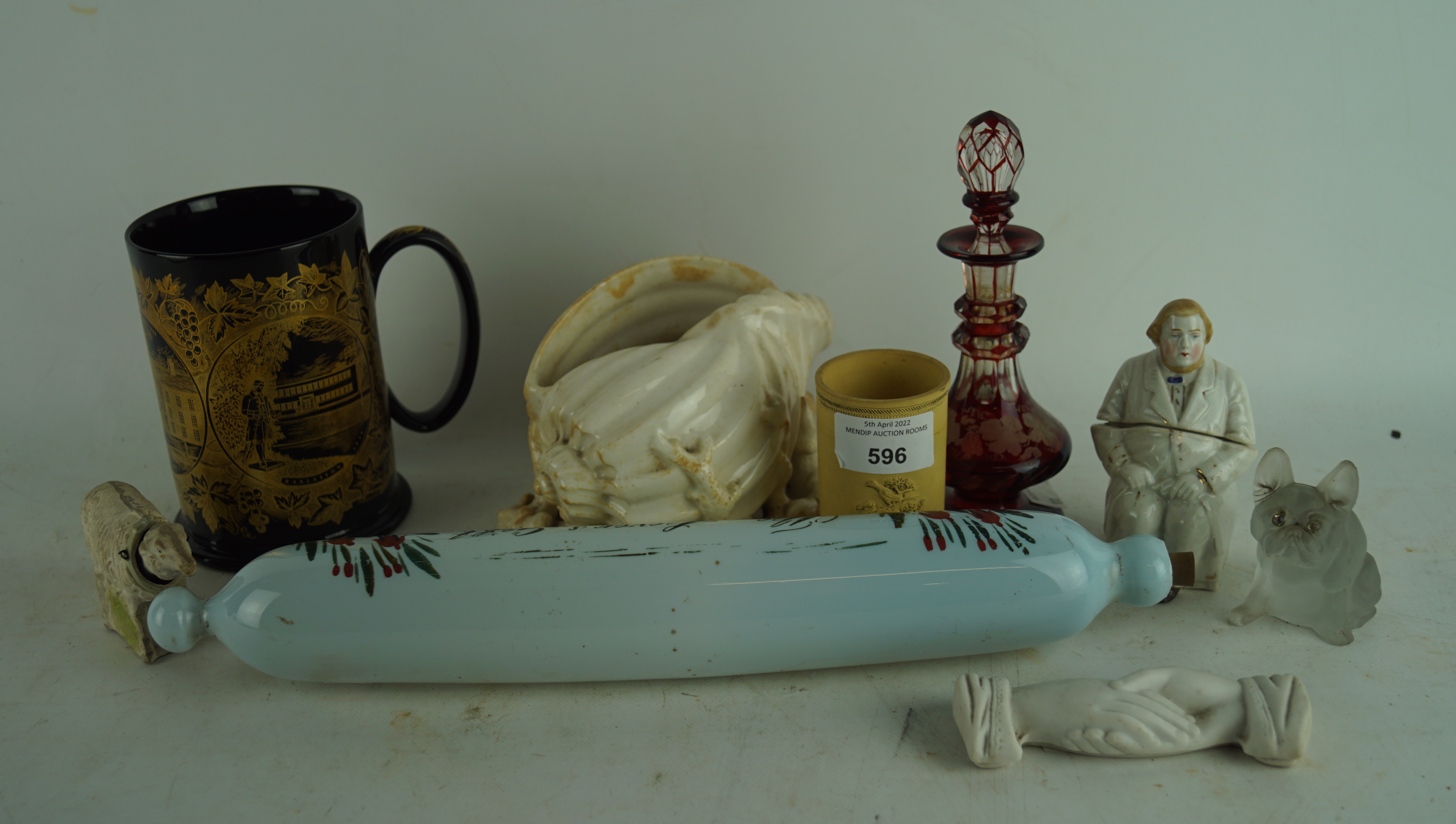 An assortment of collectables, including a glass scent bottle, rolling pin, ceramic hands,