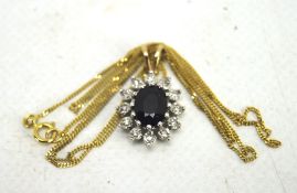 A 9ct gold sapphire and diamond cluster pendant, on a fine yellow metal chain,