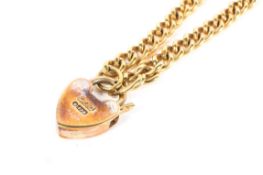 A child's 9ct gold curb link bracelet with heart locket clasp,