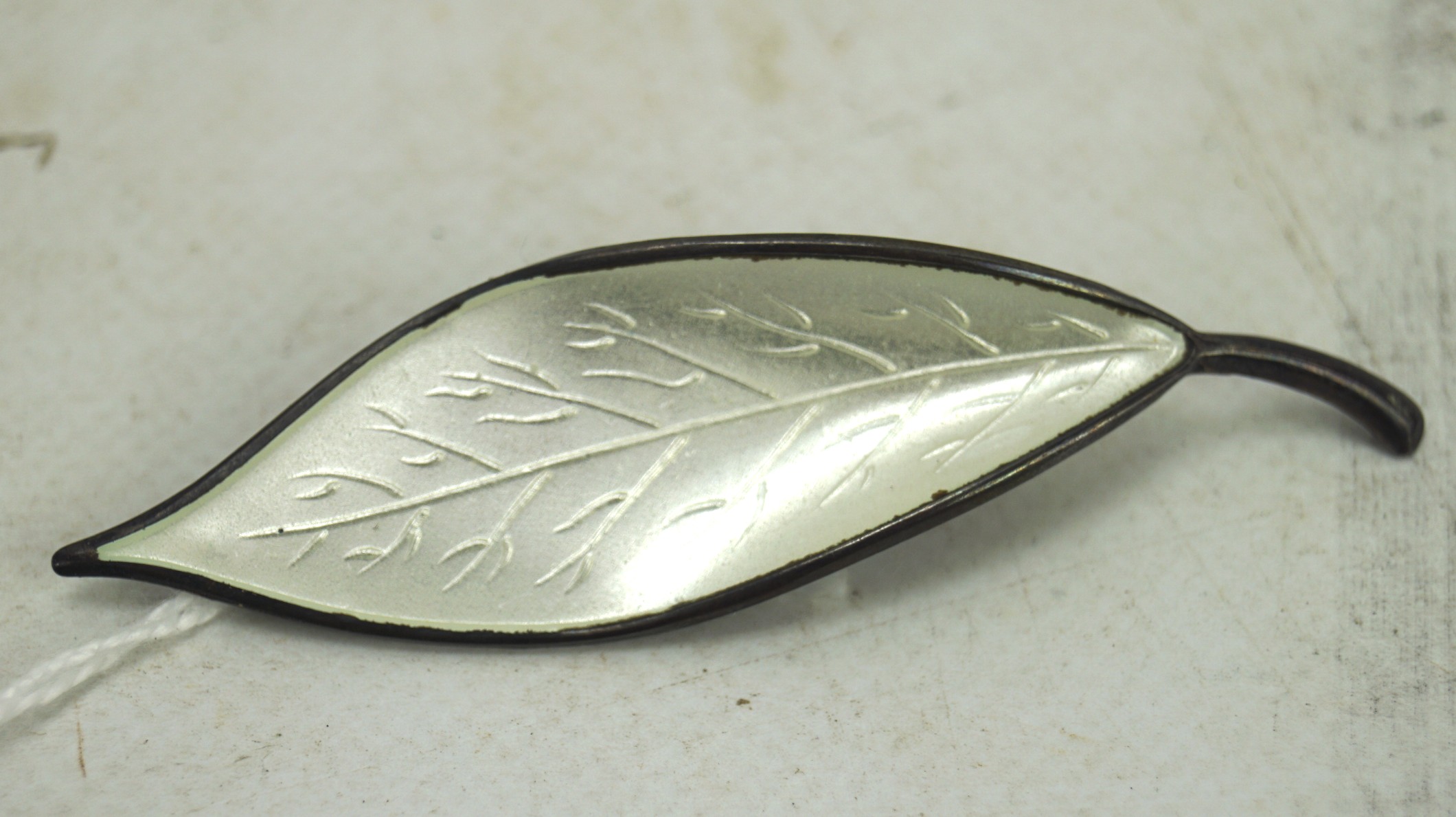 A David Anderson Norwegian sterling silver and white enamel leaf design brooch