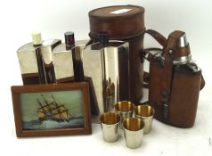 A leather cased glass hip flask and a three bottle tin lined flask,