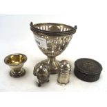 A collection of silver and white metal, including a pierced dish with a handle to the top, and more