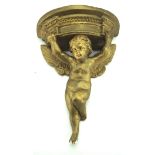 A moulded plaster and gilt wall bracket in the form of a winged cherub,