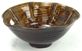 A 20th century brown glazed bowl, with fluted rim, marked 'JLJC' to base,