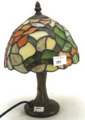 A contemporary Tiffany style lamp with coloured glass shade,