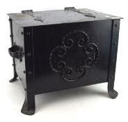 An Arts and crafts metal log box, with handles to either side and positioned on raised supports,