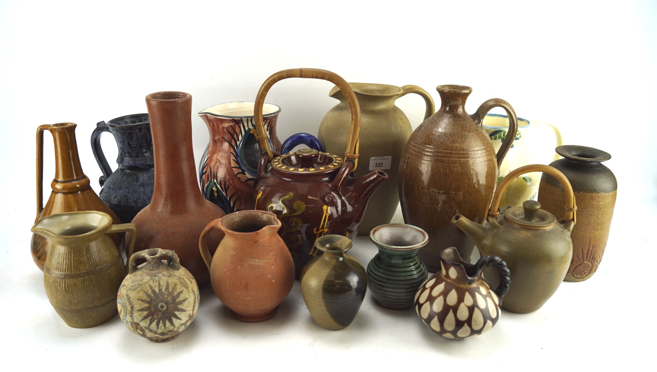 A large group of stoneware jugs and teapots with assorted glazes and patterns,