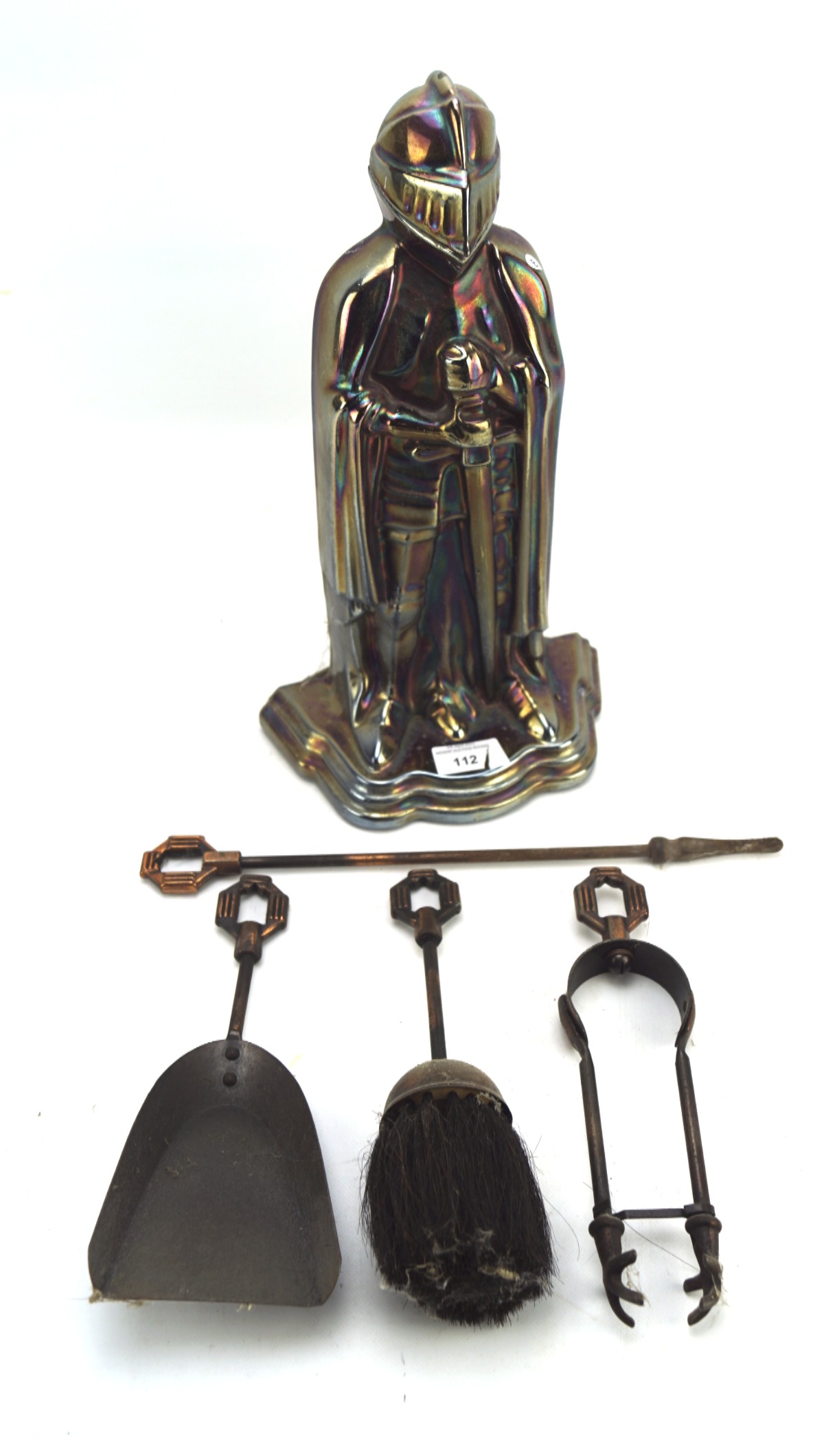 A vintage metal fireside companion set in the form of a knight,