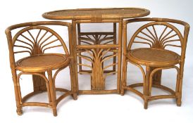 A retro wicker set of oval table and two chairs,