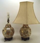 Two contemporary chinoiserie table lamps, each with floral decoration on a cream ground,