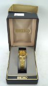A ladies Seiko wristwatch, the gilt dial with date aperture, on a gilt bracelet,