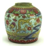 An oriental ginger jar, decorated with dragons, fish and flowers on a blue ground,