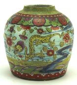 An oriental ginger jar, decorated with dragons, fish and flowers on a blue ground,