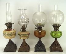 Four Victorian oil lamps with opaque and translucent glass,