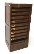 An oak roll front office cabinet,