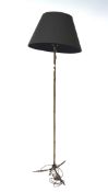 A mid-century bass standard lamp, the upright and tripod foot in bamboo form,