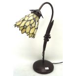 A contemporary metal Tiffany style table lamp with glass shade,