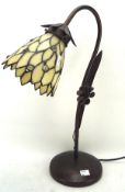 A contemporary metal Tiffany style table lamp with glass shade,