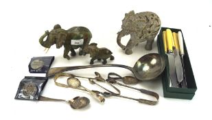 Assorted collectables, to include three stone elephants, a £5 coin, and more