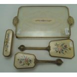 A 20th century table top four piece vanity set, including two brushes, a mirror and a tray,