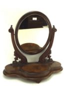 A Victorian mahogany oval dressing table swing mirror