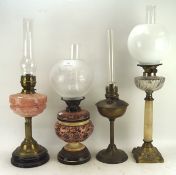 Four late 19th/early 20th century oil lamps with glass,