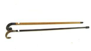 A malacca and horn handled walking stick and a silver-collared and horn handled cane,