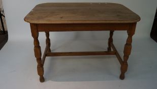 A 20th century beech dining table, raised upon turned supports,