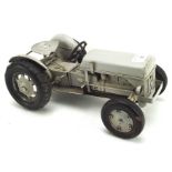 A tinplate model of a tractor, painted in grey,