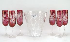 Six cranberry glass champagne flutes and a Thomas Webb vase, all with engraved decoration,