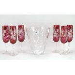 Six cranberry glass champagne flutes and a Thomas Webb vase, all with engraved decoration,