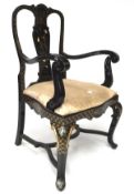 A contemporary black lacquered armchair, decorated with gilt and foliate motifs,