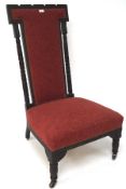 A red upholstered hall chair, with carved decoration to the seat back,