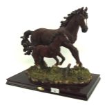 A Juliana Collection figurine set of a dark brown horse and foal, on wooden base,