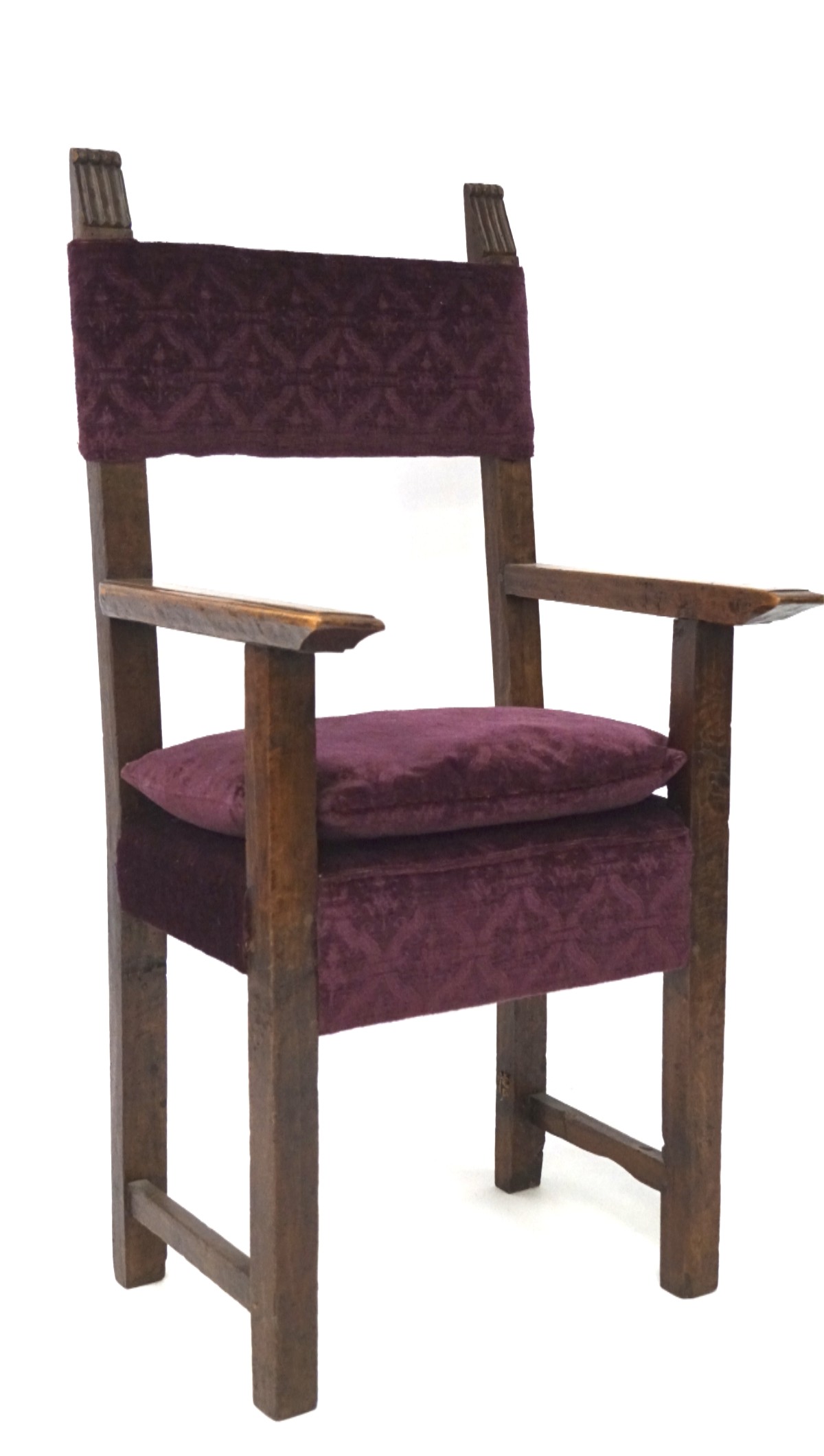 A 19th century Continental oak armchair with fluted finials of angular form,