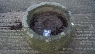 A heavy stone planter, of circular form,