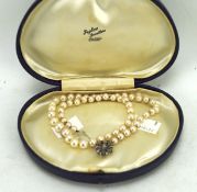 A 20th century pearl necklace with 18ct white gold clasp, the clasp set with blue stones,