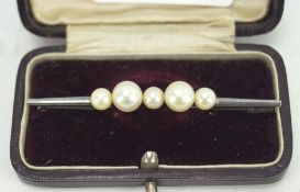 A vintage white metal pearl set bar brooch, in fitted box,