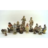 A collection of 20th century ceramic figures, modelled as animals, children and women, some marked,